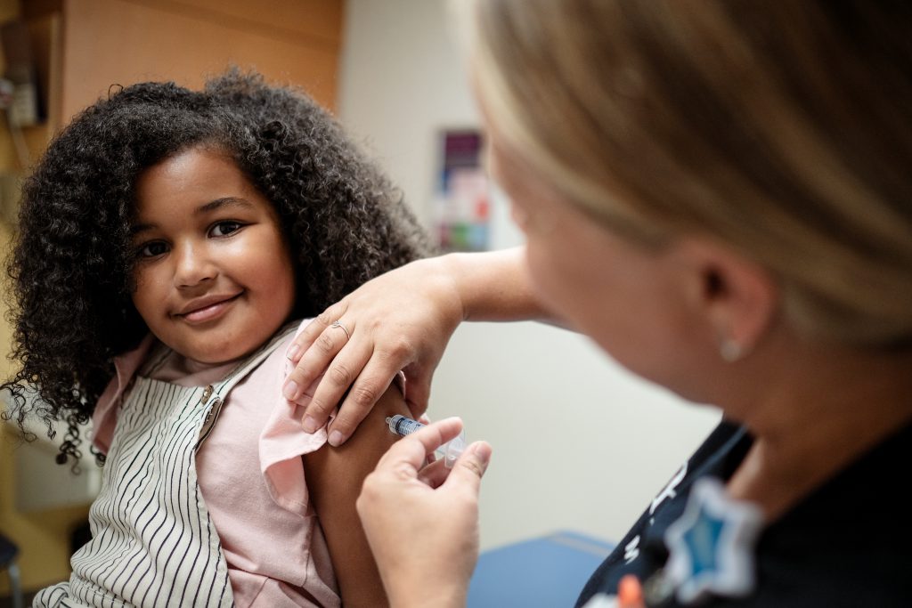 Little girl getting the flu shot vaccine