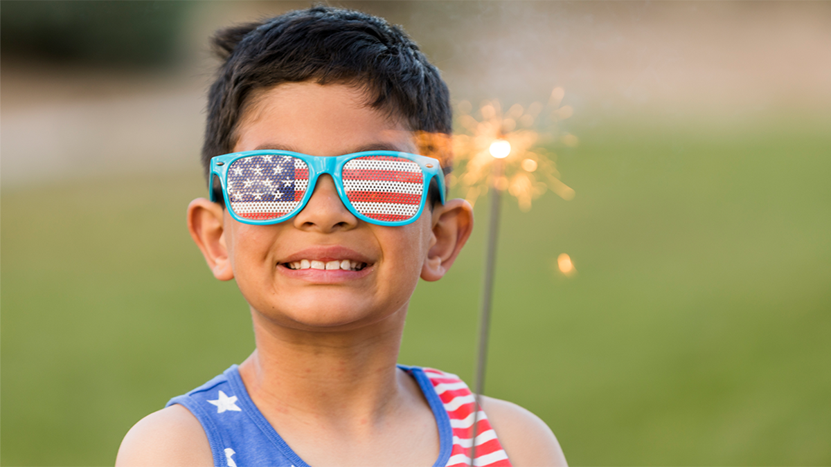 A child smiling at the camera for a 4th of July celebration