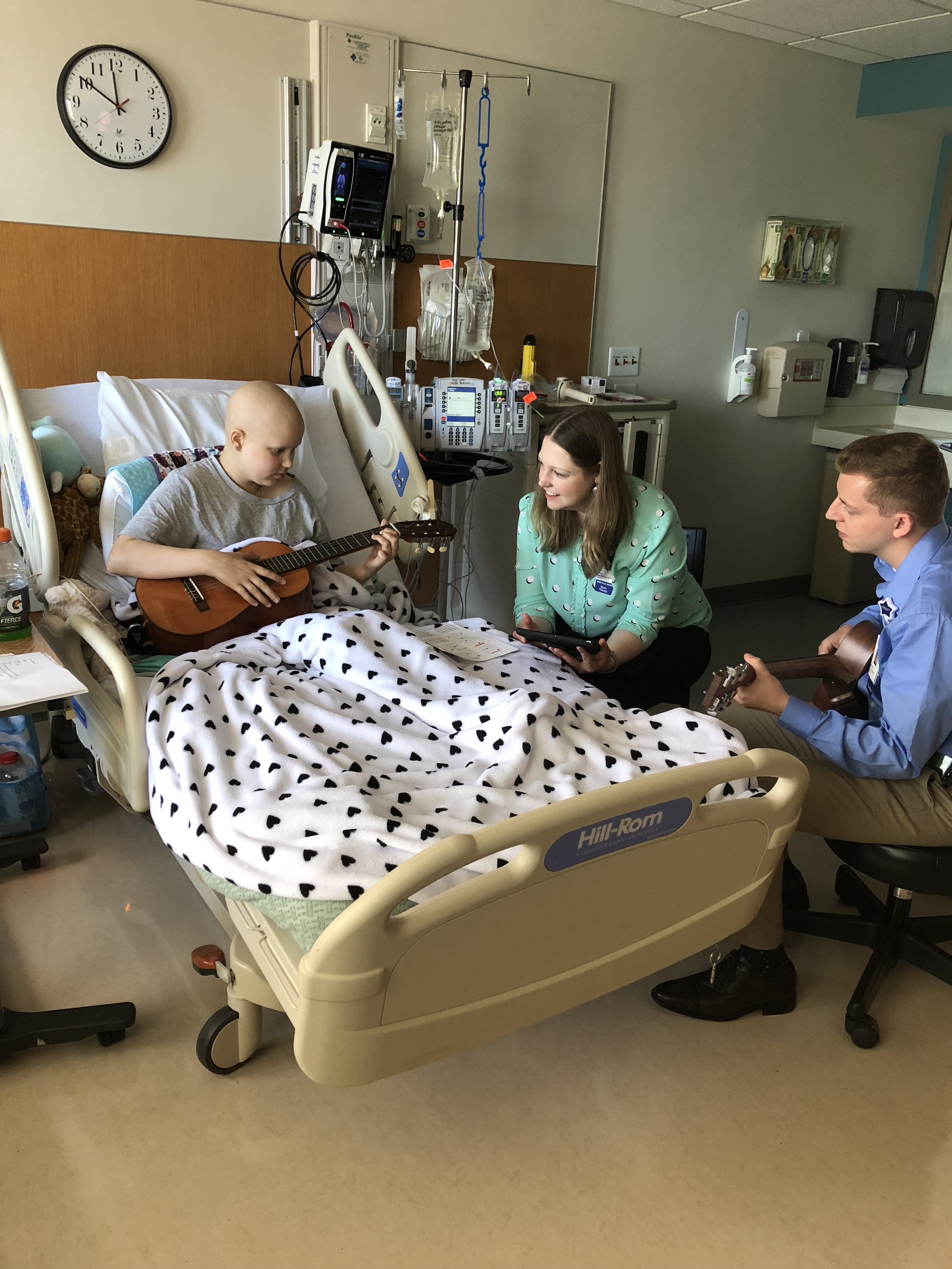 Cancer patient, Mia, with Children's music therapists