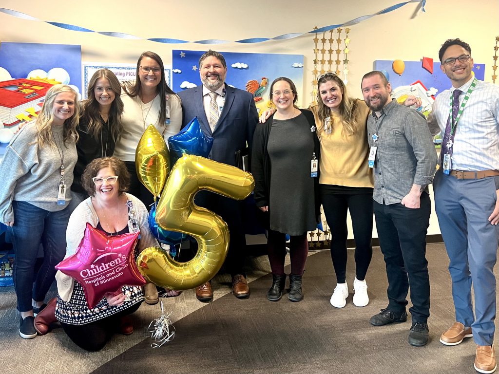 A group of people with balloons celebrating five years CLABSI free in the St. Paul PICU