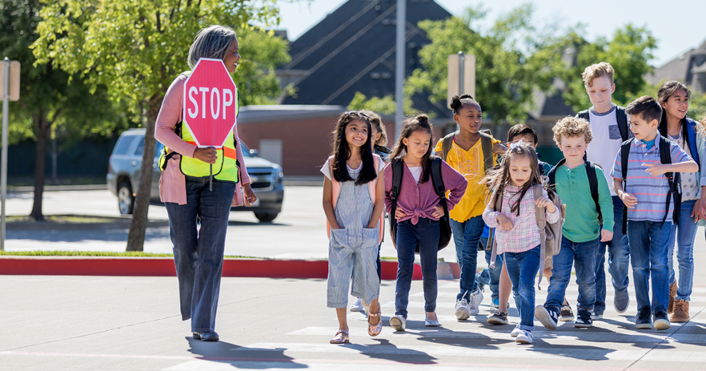 Kids safely crossing the street to school