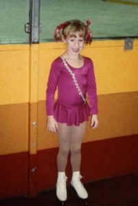 Nikki Malnar as a child in a figure skating outfit